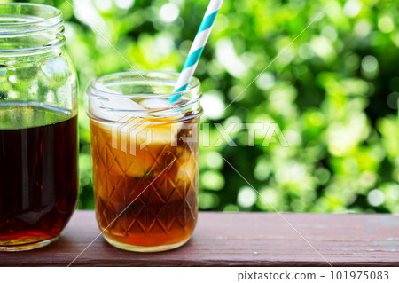 Iced coffee in mason jars outdoors 101975083