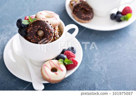 Little colorful donuts in white cup 101975087