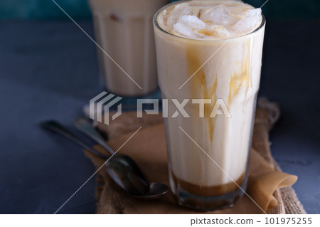 Iced coffee with milk in tall glasses 101975255