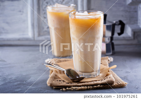 Iced coffee with milk in tall glasses 101975261