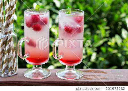 Pink raspberry lemonade in tall glasses 101975282