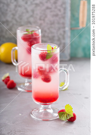 Pink raspberry lemonade in tall glasses Pink raspberry lemonade in tall glasses 101975288