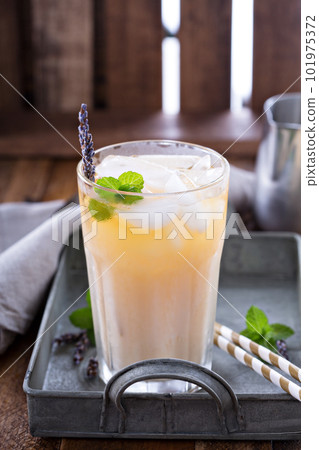 Lavender iced tea in tall glass 101975372
