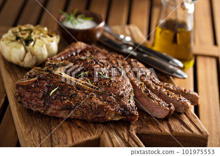 Beef steak cooked on a grill 101975553