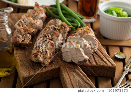 Grilled braided pork with green beans Grilled braided pork with green beans 101975573