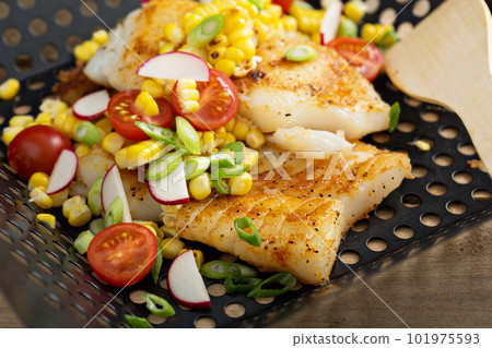 Grilled cod with summer vegetables 101975593