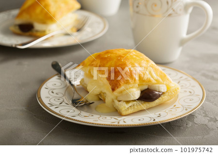 Puff pastry stacks with banana and chocolate Puff pastry stacks with banana and chocolate 101975742