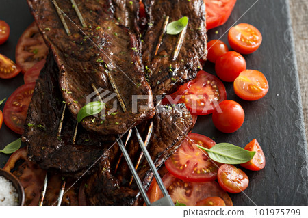 Flank steak on skewers with tomatoes 101975799