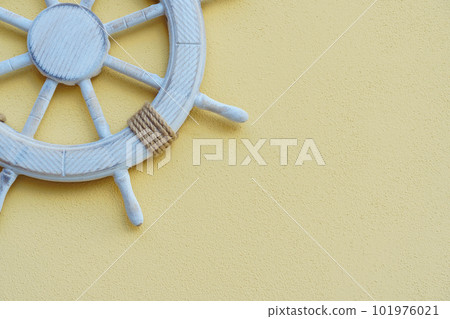 Vacation on yacht. White marine steering wheel on light background. Sea voyages and adventures. Promotional postcards. Vacation on yacht. White marine steering wheel on light background. Sea voyages and adventures. Promotional postcards. 101976021