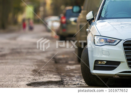 Close-up view of a new modern car parked on the side of the street Close-up view of a new modern car parked on the side of the street 101977652