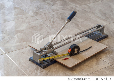 Ceramic tiles and tools for tiler. Floor tiles installation. Home improvement, renovation - ceramic tile cutting tool. 101978193