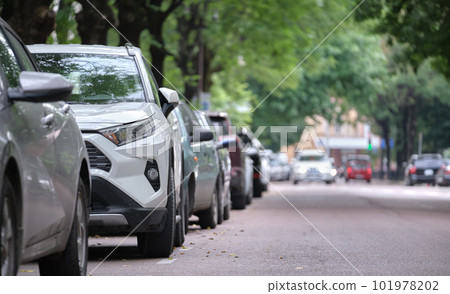 Cars parked in line on city street side. Urban traffic concept Cars parked in line on city street side. Urban traffic concept 101978202