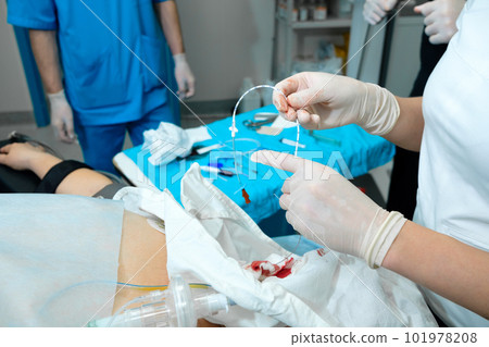 Epidural catheter in the hands of an anesthesiologist.  101978208