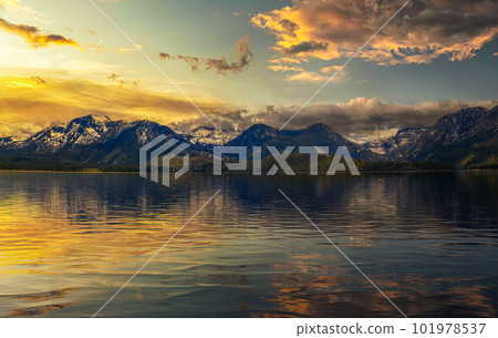 Summer sunset above Lake Tahoe with Sierra Nevada Mountains and reflection 101978537