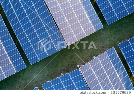 Aerial view of large sustainable electrical power plant with rows of solar photovoltaic panels for producing clean ecological electric energy. Renewable electricity with zero emission concept. 101979629