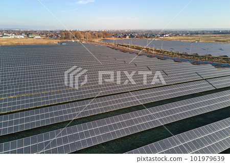 Aerial view of large sustainable electrical power plant with rows of solar photovoltaic panels for producing clean ecological electric energy. Renewable electricity with zero emission concept 101979639