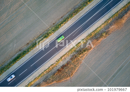 Aerial view of intercity road with fast driving cars at sunset. Top view from drone of highway traffic in evening 101979667