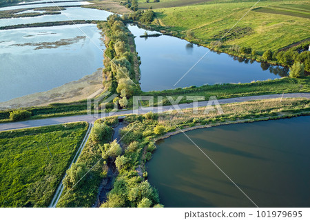 Aerial view of fish hetching pond with blue water in aquacultural area Aerial view of fish hetching pond with blue water in aquacultural area 101979695
