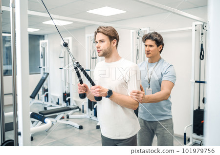 Man having a workout in a gym in a rehabilitation center Man having a workout in a gym in a rehabilitation center 101979756