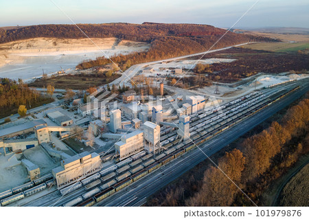 Aerial view of cargo train loaded with crushed stone materials at mining factory. Railway transportation of grinded limestone ore 101979876