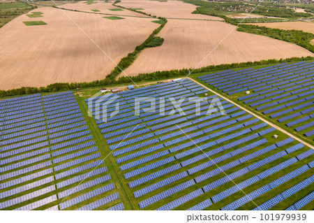 Aerial view of big sustainable electric power plant with many rows of solar photovoltaic panels for producing clean ecological electrical energy. Renewable electricity with zero emission concept. Aerial view of big sustainable electric power plant with many rows of solar photovoltaic panels for producing clean ecological electrical energy. Renewable electricity with zero emission concept. 101979939