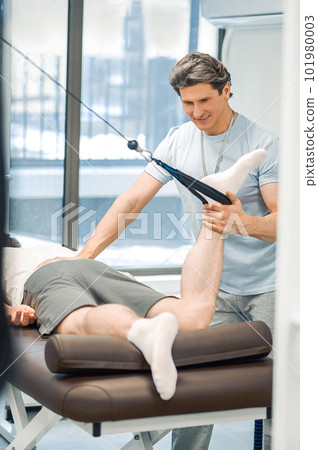 Male patient having a leg hyperextension in a rehabilitation center 101980003