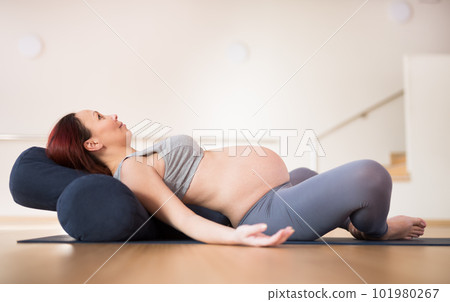pregnant woman is engaged in yoga. Reclined Bound Angle Pose or Supta Baddha Konasana pregnant woman is engaged in yoga. Reclined Bound Angle Pose or Supta Baddha Konasana 101980267