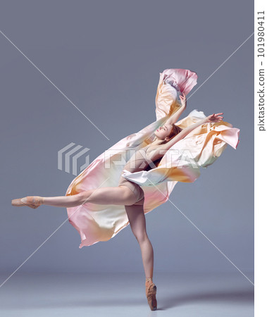 Charming ballerina dancing graceful movement with fabric over grey studio background. Gorgeous silhouette Charming ballerina dancing graceful movement with fabric over grey studio background. Gorgeous silhouette 101980411
