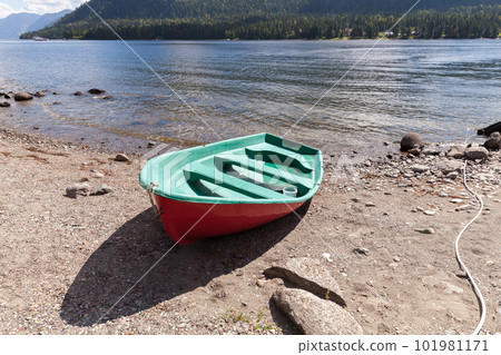 Row boat is on a coast of the Teletskoye lake. Siberia, Russia Row boat is on a coast of the Teletskoye lake. Siberia, Russia 101981171