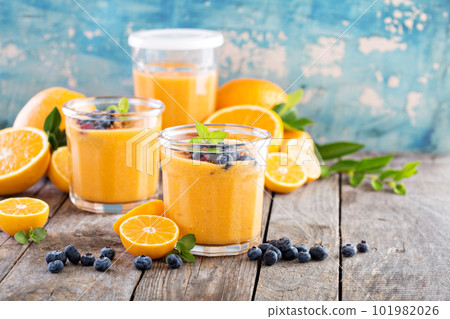 Orange and mango smoothie with granola 101982026