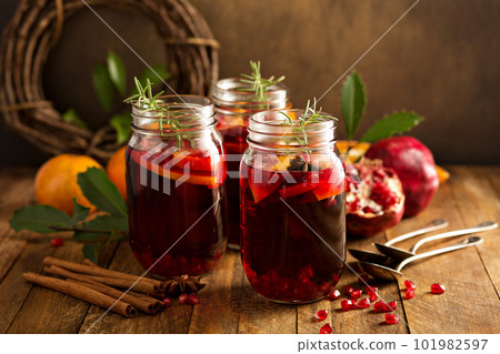 Pomegranate and orange winter cocktail Pomegranate and orange winter cocktail 101982597