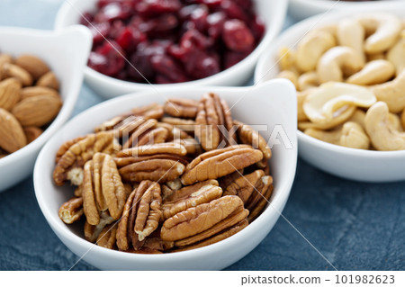 Variety of nuts and dried fruits in small bowls Variety of nuts and dried fruits in small bowls 101982623