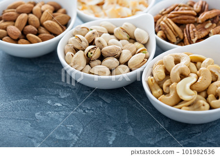 Variety of nuts in small bowls Variety of nuts in small bowls 101982636