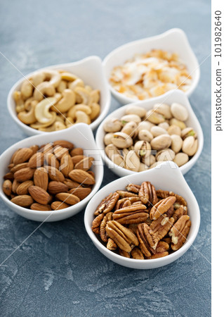 Variety of nuts in small bowls Variety of nuts in small bowls 101982640