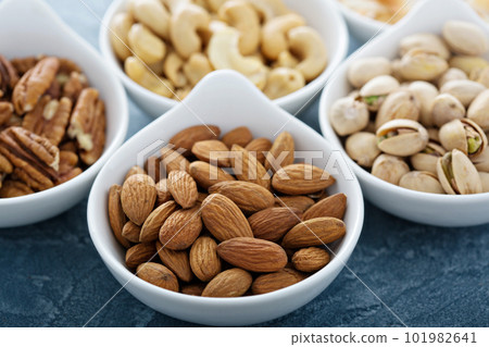 Variety of nuts in small bowls Variety of nuts in small bowls 101982641
