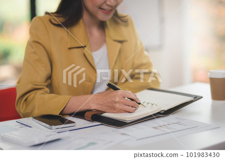 Concept of business invesment or woman working,Closeup businesswoman checking her invesment plan with analyzing document and business investment graph data by using calculator and computer laptop Concept of business invesment or woman working,Closeup businesswoman checking her invesment plan with analyzing document and business investment graph data by using calculator and computer laptop 101983430