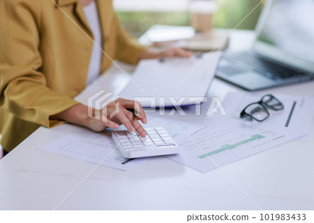 Concept of business invesment or woman working,Closeup businesswoman checking her invesment plan with analyzing document and business investment graph data by using calculator and computer laptop Concept of business invesment or woman working,Closeup businesswoman checking her invesment plan with analyzing document and business investment graph data by using calculator and computer laptop 101983433