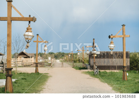 Old wooden lanterns hanging on a wooden pole along the road Old wooden lanterns hanging on a wooden pole along the road 101983688