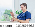 Caucasian patient using laptop in hospital room. man sick patient lying in a hospital bed 101984468