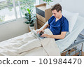Caucasian patient using laptop in hospital room. man sick patient lying in a hospital bed 101984470