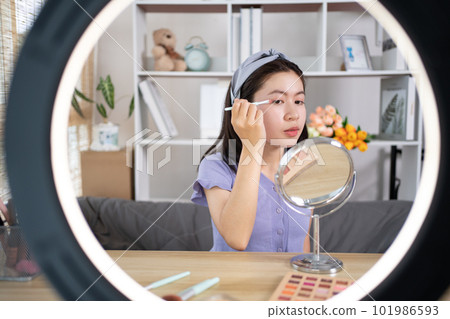 Beautiful women with social media influences are teaching makeup and use cosmetics, In front of the camera to recording vlog video live streaming, Online business on concept of beauty bloggers. Beautiful women with social media influences are teaching makeup and use cosmetics, In front of the camera to recording vlog video live streaming, Online business on concept of beauty bloggers. 101986593