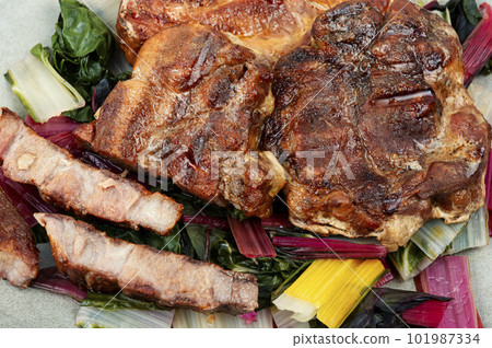 Roast meat steak with a vegetable garnish. 101987334