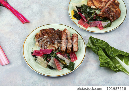 Tasty meat steak with green salad. Tasty meat steak with green salad. 101987336