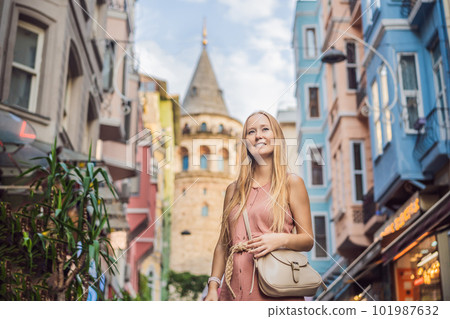 Portrait of beautiful woman tourist with view of Galata tower in Beyoglu, Istanbul, Turkey. Turkiye 101987632