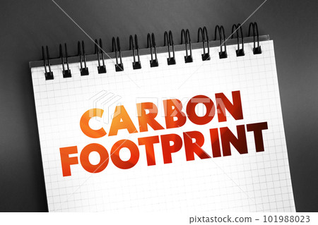 Carbon footprint - total amount of greenhouse gases that are generated by our actions, text concept on notepad 101988023