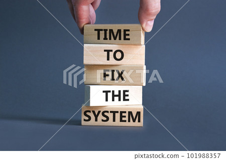 Time to fix the system symbol. Concept words Time to fix the system on wooden block. Beautiful grey table grey background. Businessman hand. Business and time to fix the system concept. Copy space. Time to fix the system symbol. Concept words Time to fix the system on wooden block. Beautiful grey table grey background. Businessman hand. Business and time to fix the system concept. Copy space. 101988357