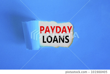 Payday loans symbol. Concept words Payday loans on beautiful white paper. Beautiful blue table blue background. Business and Payday loans concept. Copy space. 101988405