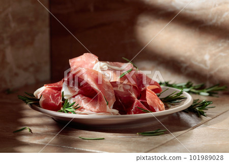 Italian prosciutto or Spanish jamon with rosemary. 101989028