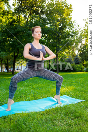 Young woman doing yoga exercises in the summer city park. Young woman doing yoga exercises in the summer city park. 101990271