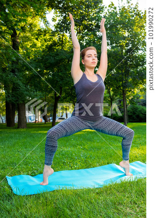 Young woman doing yoga exercises in the summer city park. Young woman doing yoga exercises in the summer city park. 101990272